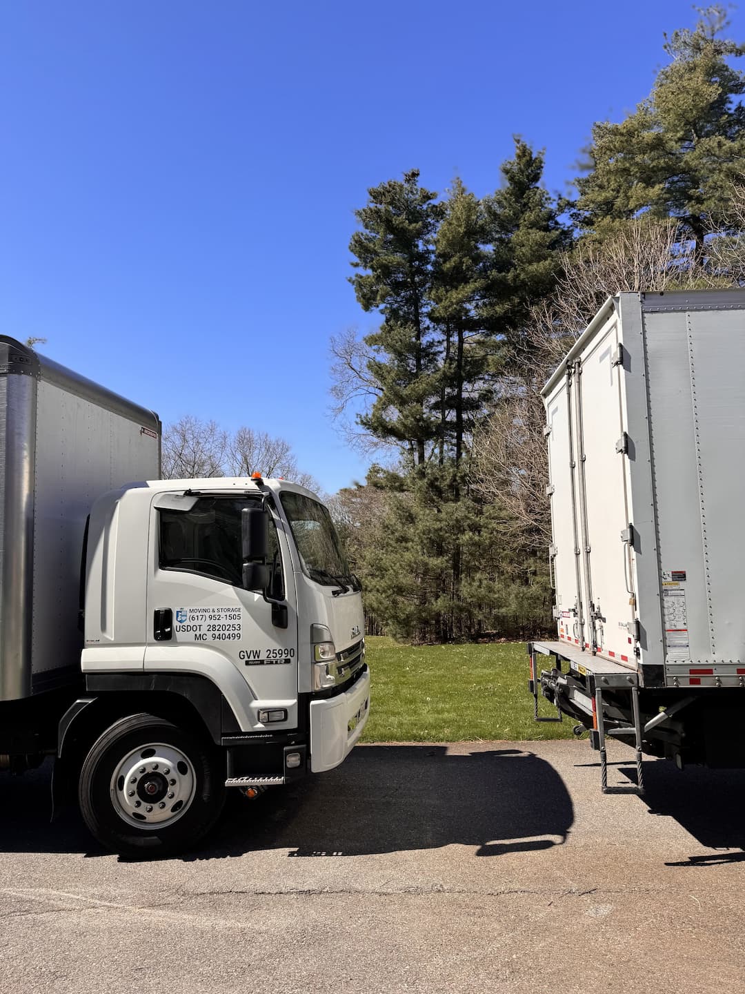 Moving trucks positioned beside a residential property