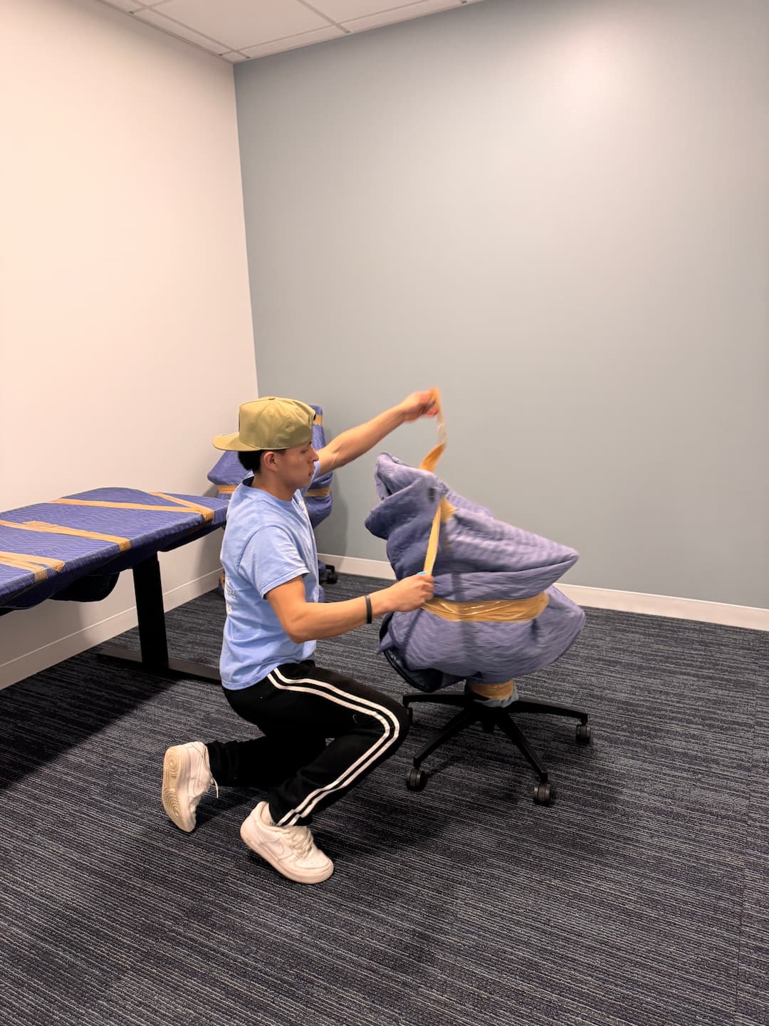 Esquire employee protecting an office chair for moving