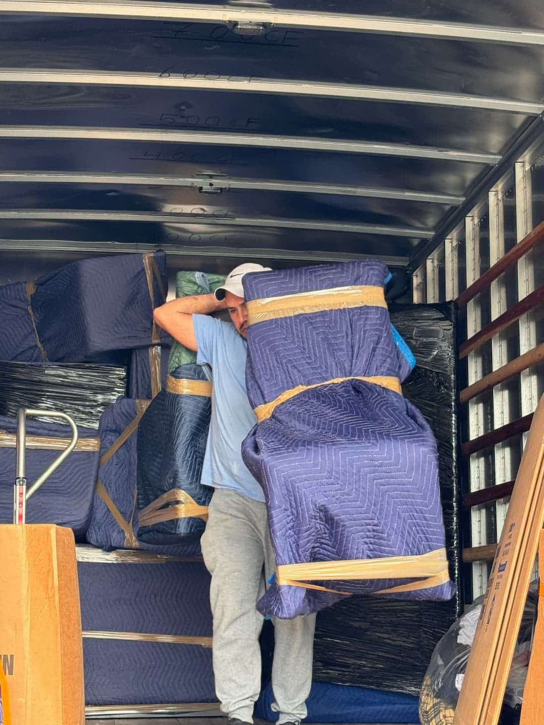 Movers protecting furniture for a Boston to Los Angeles move