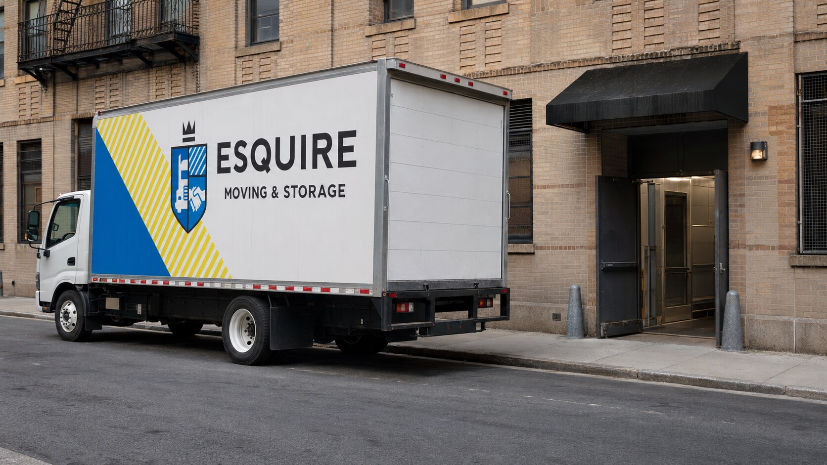 Esquire Moving truck parked beside a New York apartment service entrance