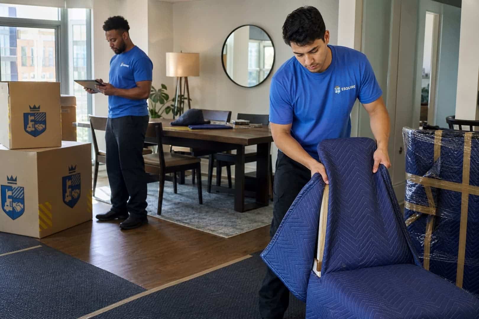 Esquire crew wrapping furniture and reviewing the moving inventory in an Alexandria condo